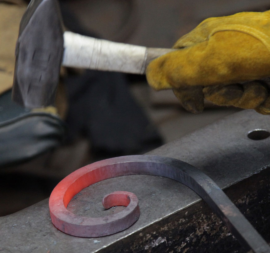 Striking an iron scroll